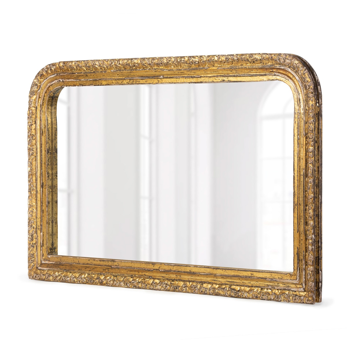 Wide carved entry mirror with an aged gold-toned frame and rounded upper corners